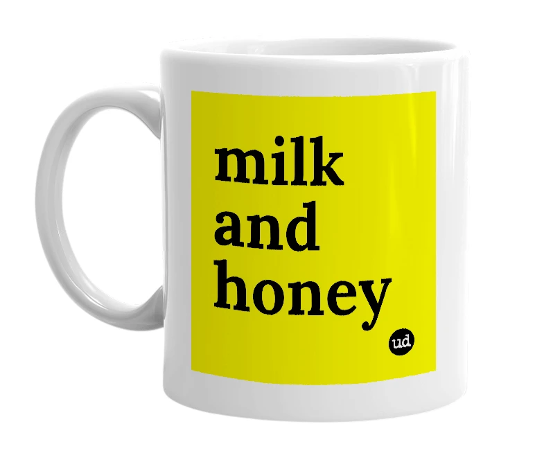 White mug with 'milk and honey' in bold black letters
