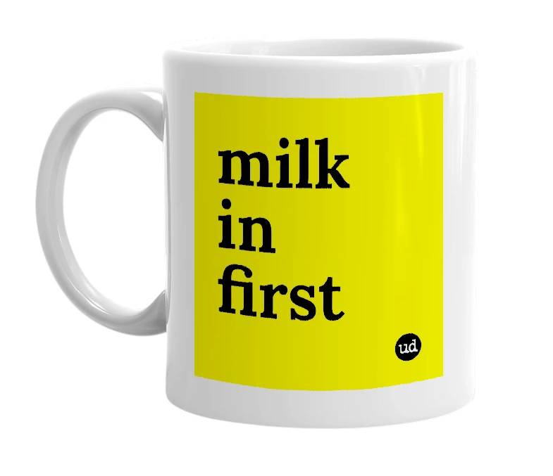 White mug with 'milk in first' in bold black letters