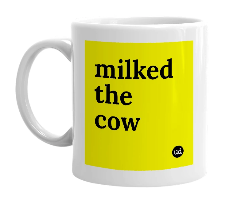 White mug with 'milked the cow' in bold black letters