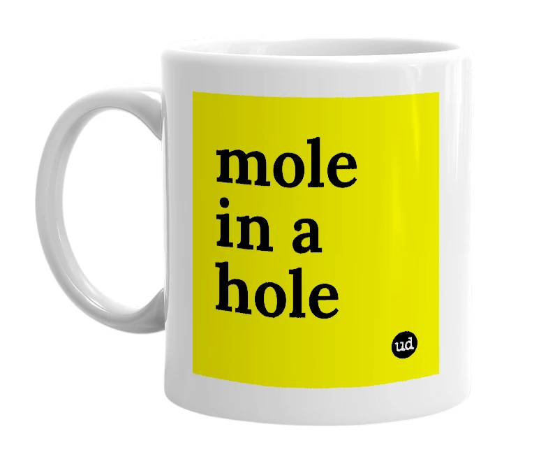 White mug with 'mole in a hole' in bold black letters