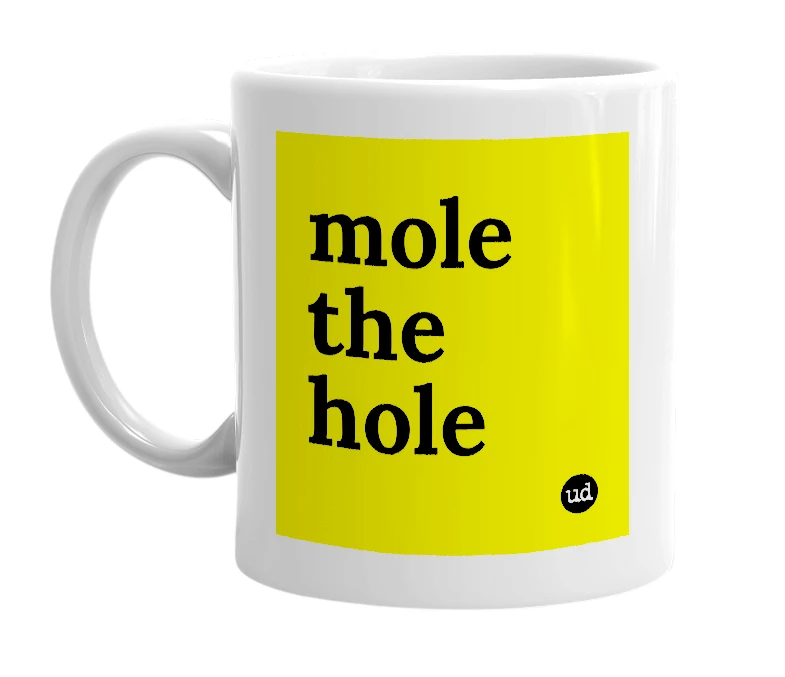 White mug with 'mole the hole' in bold black letters