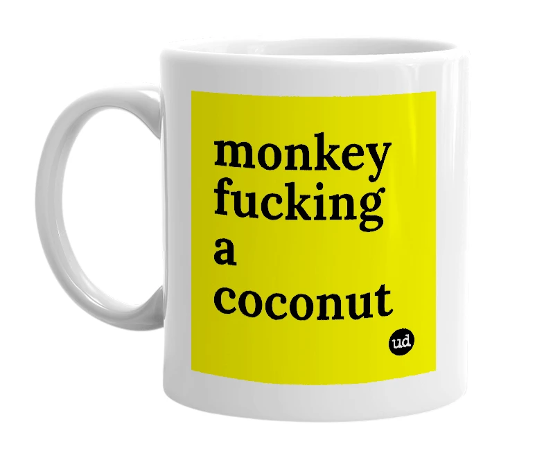 White mug with 'monkey fucking a coconut' in bold black letters