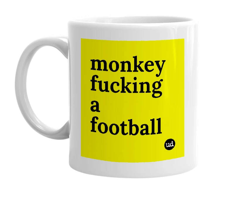 White mug with 'monkey fucking a football' in bold black letters