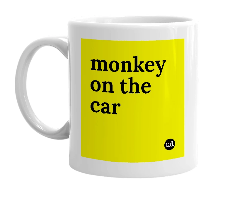 White mug with 'monkey on the car' in bold black letters