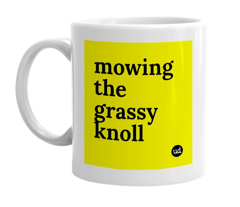 White mug with 'mowing the grassy knoll' in bold black letters