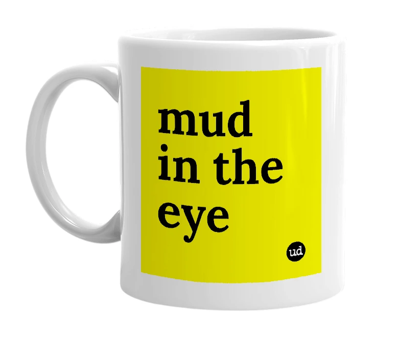 White mug with 'mud in the eye' in bold black letters