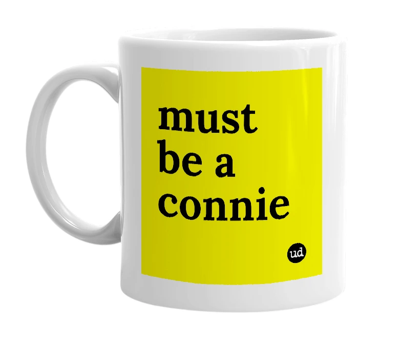 White mug with 'must be a connie' in bold black letters