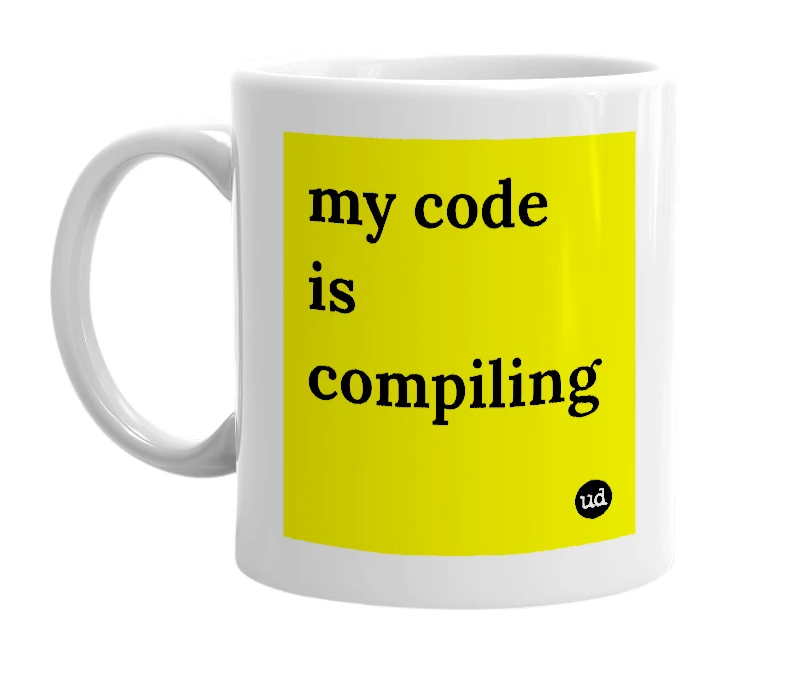 White mug with 'my code is compiling' in bold black letters