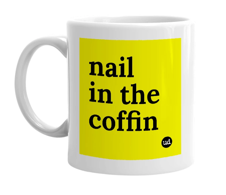 White mug with 'nail in the coffin' in bold black letters