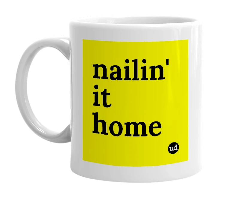 White mug with 'nailin' it home' in bold black letters