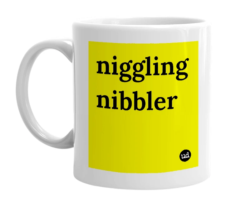 White mug with 'niggling nibbler' in bold black letters
