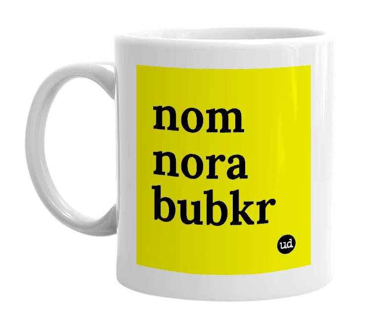 White mug with 'nom nora bubkr' in bold black letters