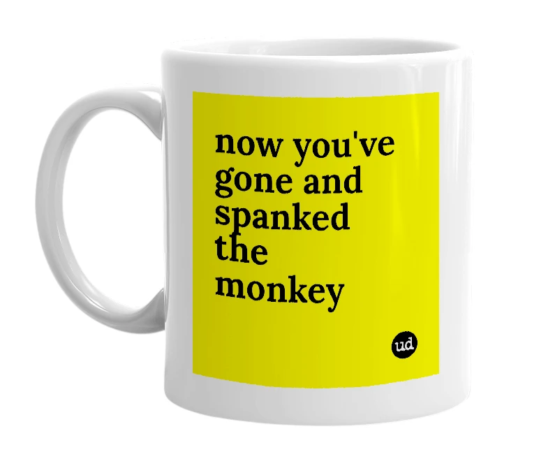 White mug with 'now you've gone and spanked the monkey' in bold black letters