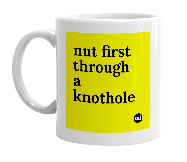 White mug with 'nut first through a knothole' in bold black letters