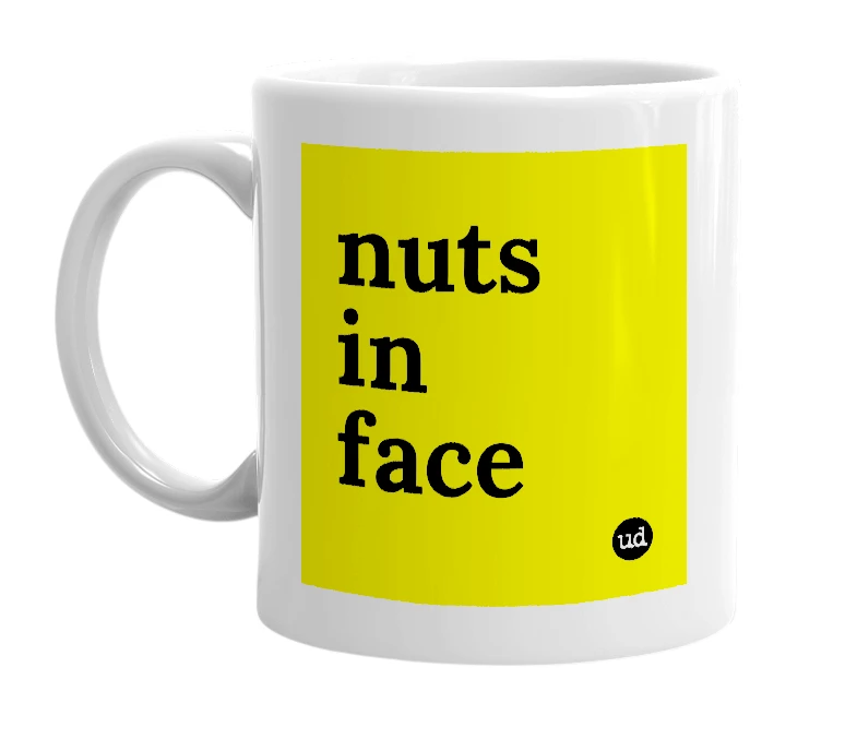 White mug with 'nuts in face' in bold black letters