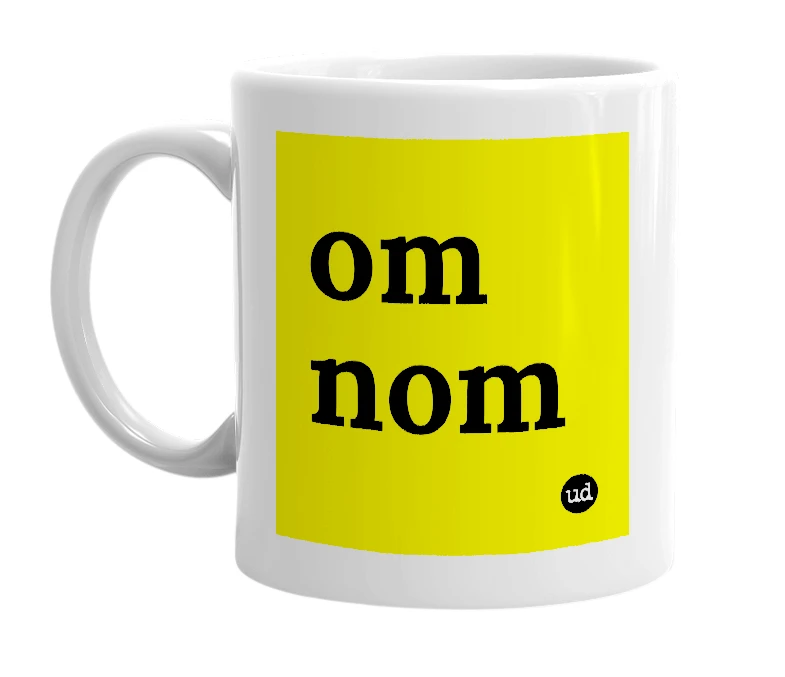 White mug with 'om nom' in bold black letters