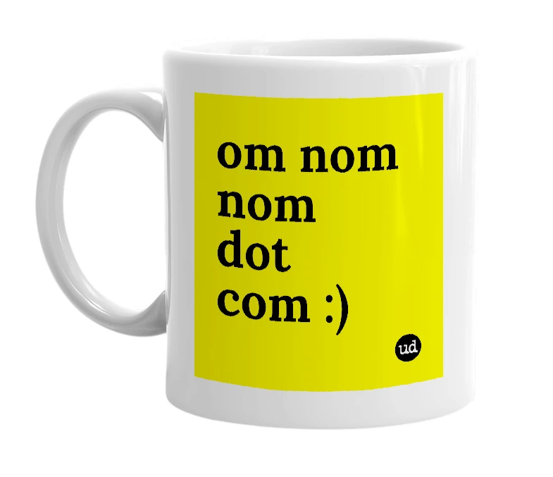 White mug with 'om nom nom dot com :)' in bold black letters