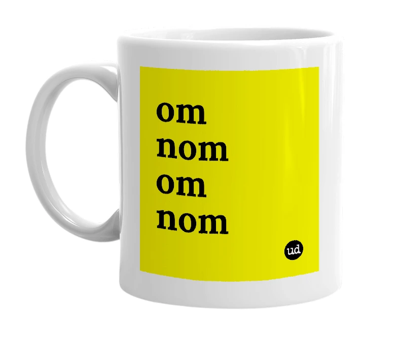 White mug with 'om nom om nom' in bold black letters