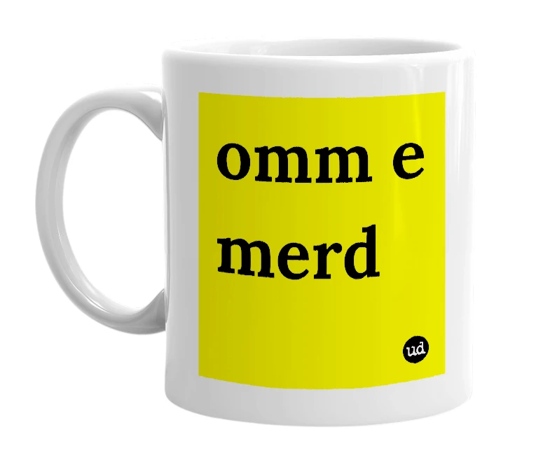White mug with 'omm e merd' in bold black letters