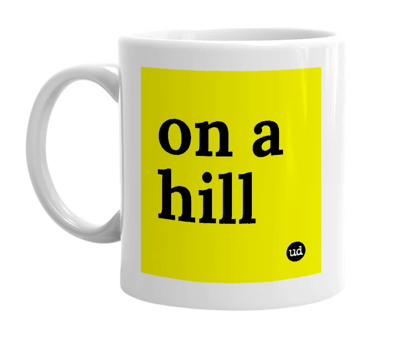 White mug with 'on a hill' in bold black letters