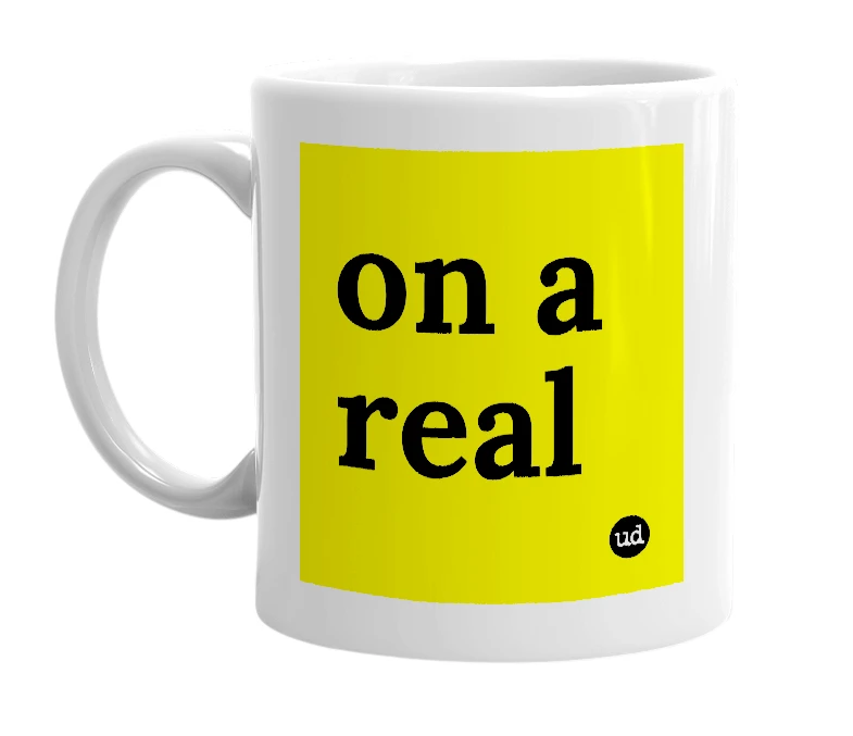 White mug with 'on a real' in bold black letters