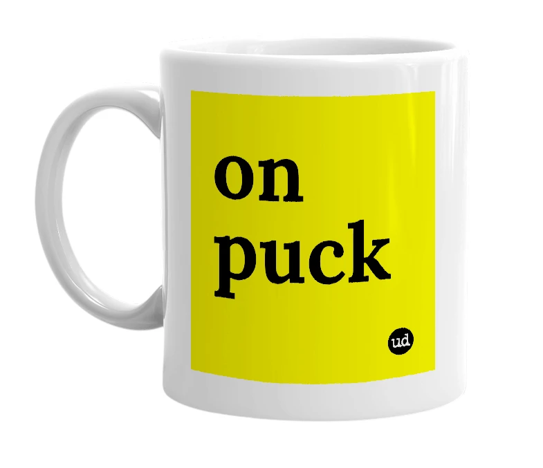 White mug with 'on puck' in bold black letters