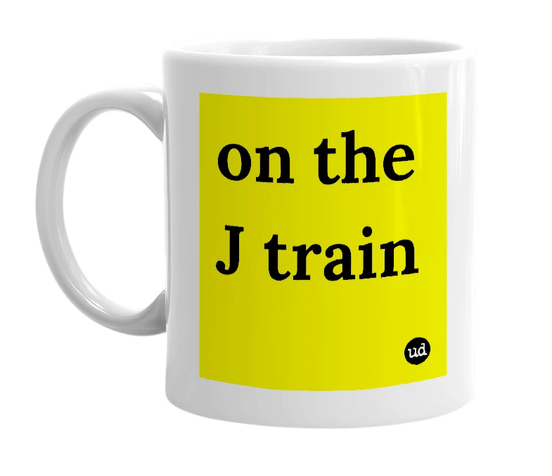 White mug with 'on the J train' in bold black letters