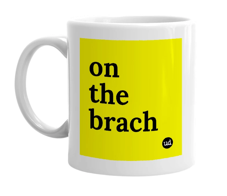 White mug with 'on the brach' in bold black letters