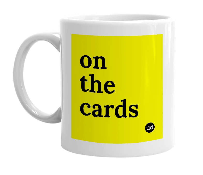 White mug with 'on the cards' in bold black letters