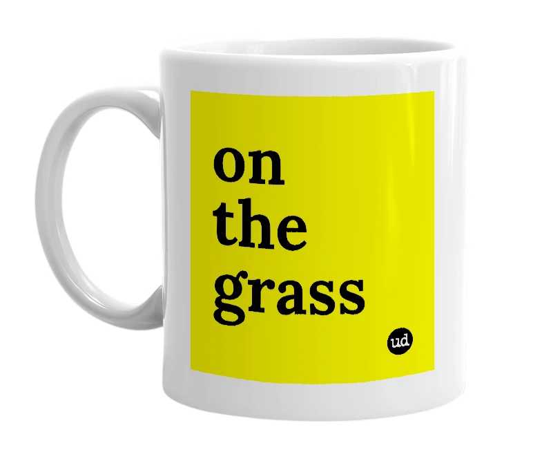 White mug with 'on the grass' in bold black letters