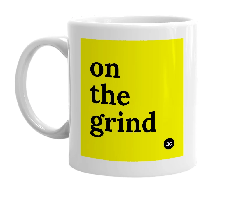 White mug with 'on the grind' in bold black letters