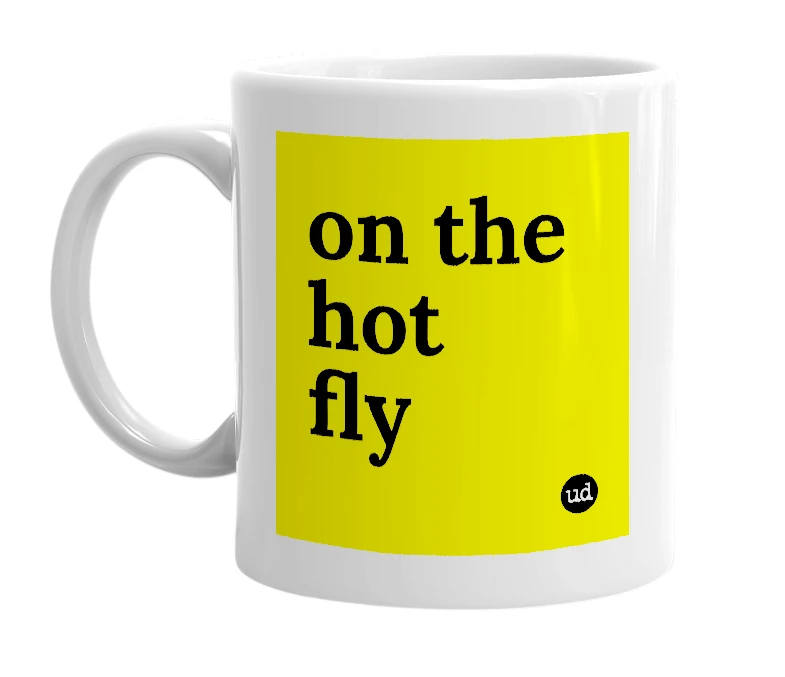 White mug with 'on the hot fly' in bold black letters