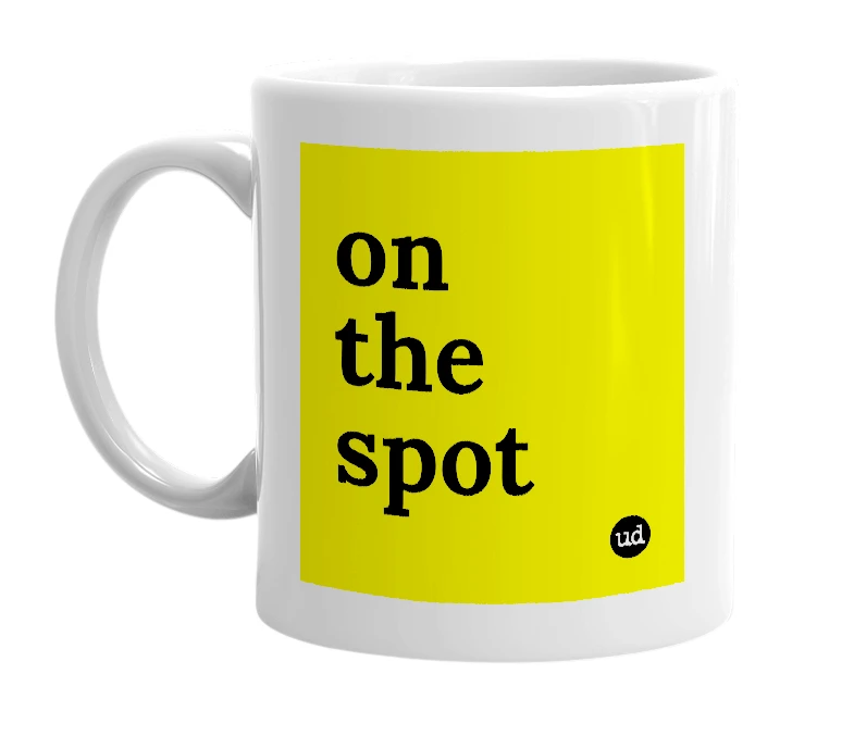 White mug with 'on the spot' in bold black letters