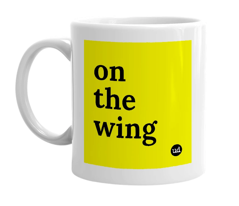White mug with 'on the wing' in bold black letters