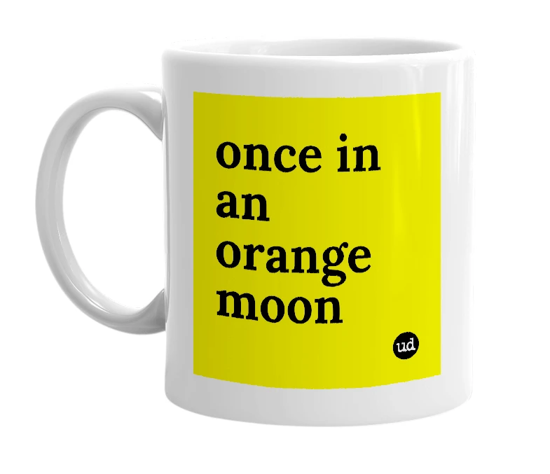 White mug with 'once in an orange moon' in bold black letters