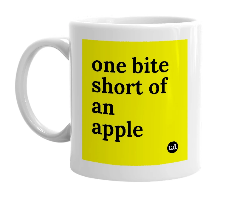 White mug with 'one bite short of an apple' in bold black letters