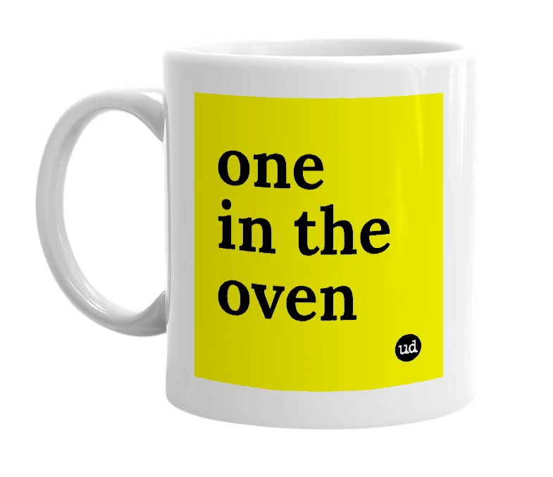 White mug with 'one in the oven' in bold black letters