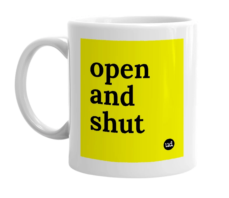 White mug with 'open and shut' in bold black letters