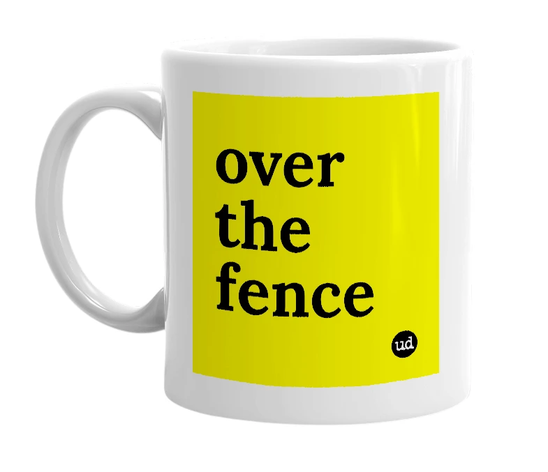 White mug with 'over the fence' in bold black letters