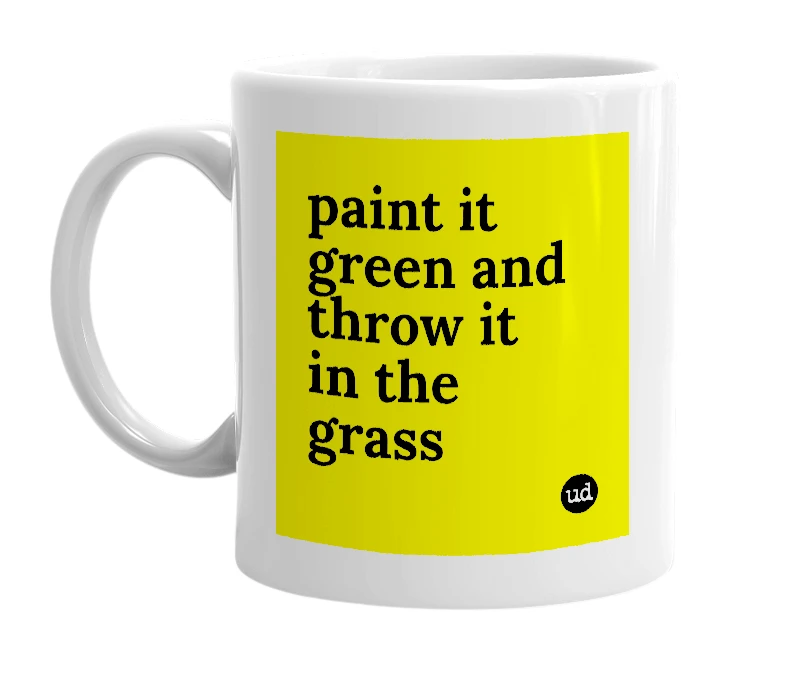 White mug with 'paint it green and throw it in the grass' in bold black letters