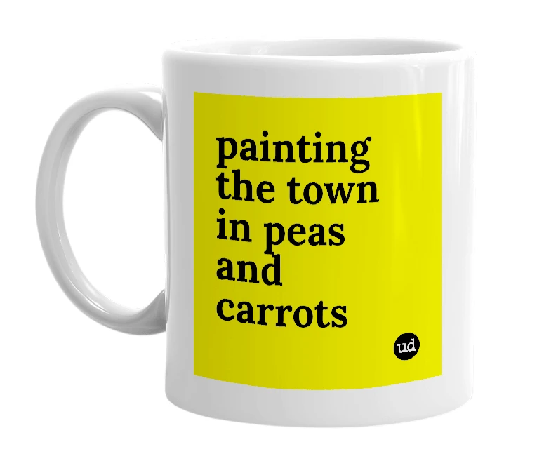White mug with 'painting the town in peas and carrots' in bold black letters