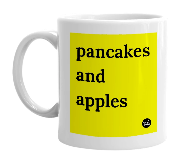 White mug with 'pancakes and apples' in bold black letters