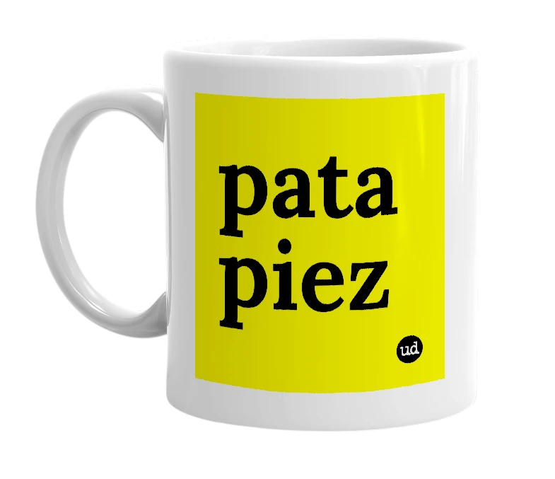 White mug with 'pata piez' in bold black letters