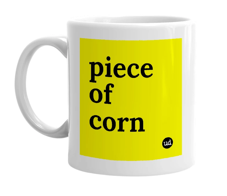 White mug with 'piece of corn' in bold black letters