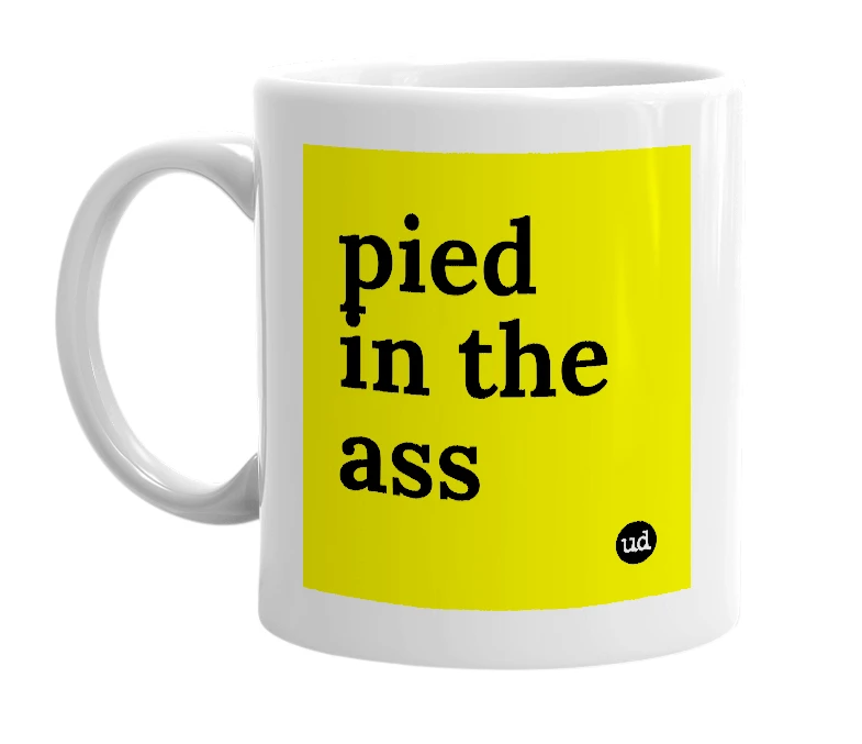 White mug with 'pied in the ass' in bold black letters