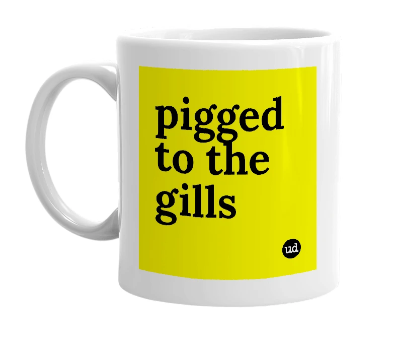 White mug with 'pigged to the gills' in bold black letters