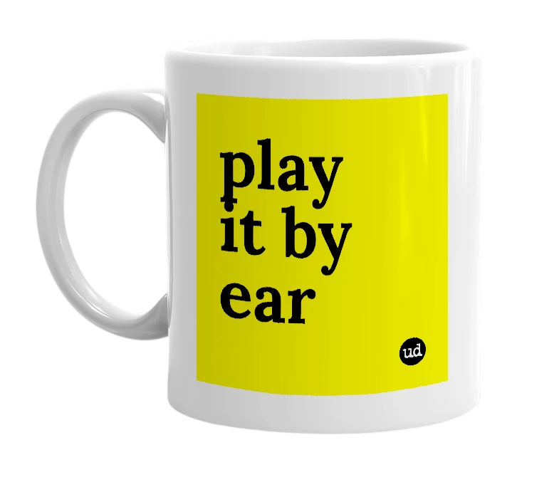 White mug with 'play it by ear' in bold black letters