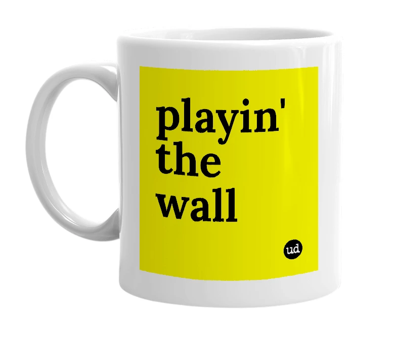 White mug with 'playin' the wall' in bold black letters