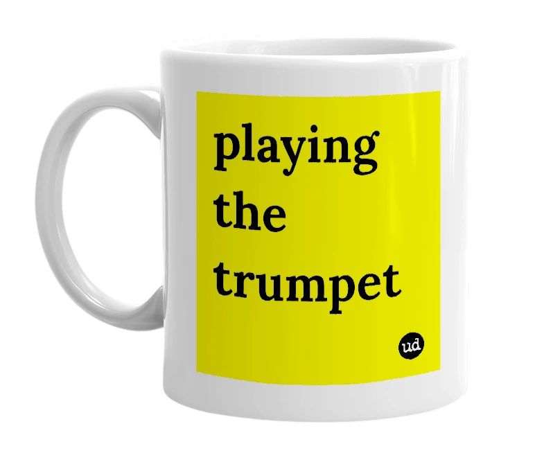White mug with 'playing the trumpet' in bold black letters