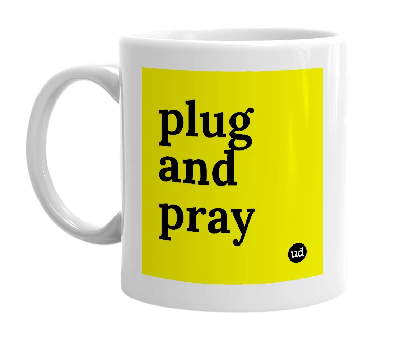 White mug with 'plug and pray' in bold black letters